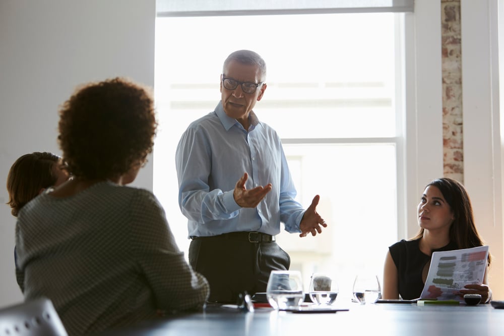 gentleman leading boardroom meeting